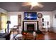 Cozy living room featuring a fireplace, wood floors, and a ceiling fan for added comfort at 1899 Se Cooper Landing Se Dr, Smyrna, GA 30080