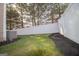 A well maintained backyard with a white fence, and mulch surrounding the perimeter at 5790 Ridge Stone Way, Cumming, GA 30041