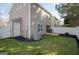 Enjoy outdoor living in this home's backyard with white fence, green grass and mulch at 5790 Ridge Stone Way, Cumming, GA 30041