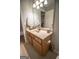 Bathroom features a wooden vanity with a white countertop, and a decorative mirror at 5790 Ridge Stone Way, Cumming, GA 30041