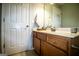 Bathroom features a wooden vanity with a white countertop, and a decorative mirror at 5790 Ridge Stone Way, Cumming, GA 30041