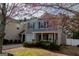 Charming two-story home with gray siding, black shutters, covered porch, and landscaped front yard at 5790 Ridge Stone Way, Cumming, GA 30041