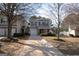 Charming two-story home with gray siding, black shutters, covered porch, and a well-manicured front yard at 5790 Ridge Stone Way, Cumming, GA 30041