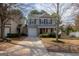 Charming two-story home with gray siding, black shutters, covered porch, and a well-manicured front yard at 5790 Ridge Stone Way, Cumming, GA 30041