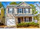 Charming two-story home with stone accents, attached garage and manicured landscaping at 5790 Ridge Stone Way, Cumming, GA 30041