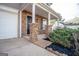 Covered front porch with stone columns, a black front door, landscaping, and a concrete pathway at 5790 Ridge Stone Way, Cumming, GA 30041