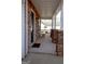 Covered front porch with stone columns and a black front door with chair seating at 5790 Ridge Stone Way, Cumming, GA 30041