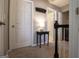 Upstairs hallway featuring neutral carpet, updated lighting, and access to the bedrooms at 5790 Ridge Stone Way, Cumming, GA 30041