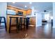 Open kitchen view featuring wooden cabinets, stainless appliances, and hardwood floors at 5790 Ridge Stone Way, Cumming, GA 30041