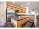 Kitchen with stainless steel appliances, wooden cabinetry, and a breakfast bar with seating at 5790 Ridge Stone Way, Cumming, GA 30041