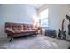 Inviting living room featuring a brown leather sofa and a guitar amplifier for entertainment at 5790 Ridge Stone Way, Cumming, GA 30041