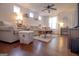 Bright living room with hardwood floors, neutral-toned furniture, recessed lighting, and natural light at 5790 Ridge Stone Way, Cumming, GA 30041