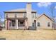 Backyard view of home featuring a covered patio with outdoor seating and a hot tub at 224 Jester Ct, Mcdonough, GA 30252