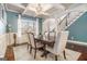 Elegant dining room with coffered ceilings, a stylish chandelier, and a table set for six, next to staircase at 224 Jester Ct, Mcdonough, GA 30252