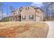 Inviting two-story brick home featuring dark shutters and a spacious front yard with an attached two-car garage at 224 Jester Ct, Mcdonough, GA 30252