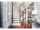 Bright foyer with hardwood floors, staircase with wooden banister, and views into the living spaces at 224 Jester Ct, Mcdonough, GA 30252