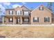 Charming two-story brick home with a covered front porch and classic dark shutters, offering curb appeal at 224 Jester Ct, Mcdonough, GA 30252