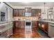 Well-equipped kitchen featuring dark wood cabinets, stainless steel appliances, and hardwood flooring for style at 224 Jester Ct, Mcdonough, GA 30252