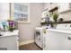 A laundry room offering shelving, storage, and a large window for natural light at 224 Jester Ct, Mcdonough, GA 30252