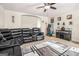 Cozy living room features a leather sectional sofa, a bar, and an arcade game for entertainment at 224 Jester Ct, Mcdonough, GA 30252