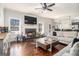 Inviting living room showcasing a fireplace, large windows, hardwood floors, and an open layout for entertaining at 224 Jester Ct, Mcdonough, GA 30252