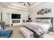 A main bedroom with a tray ceiling, tv, fireplace, and an adjacent ensuite at 224 Jester Ct, Mcdonough, GA 30252