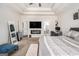 Relaxing main bedroom with a ceiling fan, electric fireplace, and a comfortable chaise lounge at 224 Jester Ct, Mcdonough, GA 30252