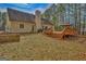 View of the house from backyard, showing large deck and mature trees at 130 Kingsbrooke Cir, Palmetto, GA 30268