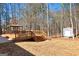 Backyard with spacious deck, gazebo, shed, and mature trees, offering outdoor enjoyment and storage at 130 Kingsbrooke Cir, Palmetto, GA 30268