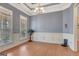 Formal dining room with tray ceiling, wainscoting, and natural light from large windows at 130 Kingsbrooke Cir, Palmetto, GA 30268