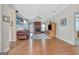 Cozy living room featuring a brick fireplace, plush sofa, and hardwood floors at 130 Kingsbrooke Cir, Palmetto, GA 30268