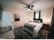 Cozy bedroom features a ceiling fan, a comfortable bed, and wood flooring at 2508 Sylvan Rd, East Point, GA 30344