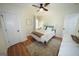 Comfortable bedroom features wood floors, a ceiling fan, a closet, and a dresser at 2508 Sylvan Rd, East Point, GA 30344