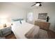 Bright bedroom with a wooden dresser, a comfortable bed with accent pillows, and wood flooring at 2508 Sylvan Rd, East Point, GA 30344