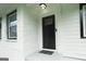 Close-up of a freshly painted front door, framed by brick and modern windows at 2508 Sylvan Rd, East Point, GA 30344