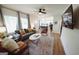 Bright living room featuring modern furniture, wood floors, and open floor plan at 2508 Sylvan Rd, East Point, GA 30344