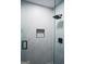Luxurious shower with white marble-style tile, black hardware, glass door, and a shower niche at 2508 Sylvan Rd, East Point, GA 30344