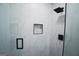 Modern shower features sleek white tile and black hardware including rainfall shower head and shelves at 2508 Sylvan Rd, East Point, GA 30344