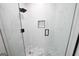 A beautifully designed shower featuring marble-like walls and a unique hexagon-tiled floor for a modern feel at 2508 Sylvan Rd, East Point, GA 30344