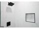 Modern shower features sleek white tile and black hardware including rainfall shower head and shelf at 2508 Sylvan Rd, East Point, GA 30344