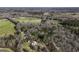 Stunning aerial view showcasing the serene property with a pond, nestled among lush trees and sprawling greenery at 128 Turner Ln, Bowdon, GA 30108