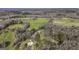 Expansive aerial view showcasing the property surrounded by lush trees and green fields at 128 Turner Ln, Bowdon, GA 30108