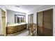 Bathroom featuring double closets, a vanity with wood cabinets, and modern lighting at 128 Turner Ln, Bowdon, GA 30108