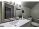 Bathroom featuring a large mirror, white countertops, and modern fixtures at 128 Turner Ln, Bowdon, GA 30108
