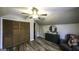 Attic bedroom featuring wood floors, storage options, decor, and gray furnishings at 128 Turner Ln, Bowdon, GA 30108