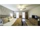 Well lit bedroom with a statement wall, ceiling fan and views of bedroom furnishings and décor at 128 Turner Ln, Bowdon, GA 30108