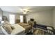Bright bedroom featuring wood floors, plank wall, and views of bedroom furnishings and décor at 128 Turner Ln, Bowdon, GA 30108