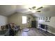 Attic bedroom featuring wood floors, gray furnishings, window and ceiling fan at 128 Turner Ln, Bowdon, GA 30108