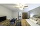 Bedroom showcasing a guest daybed, ceiling fan, plank wall, and wood flooring at 128 Turner Ln, Bowdon, GA 30108
