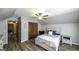 Attic bedroom showcasing wood floors, neutral walls, and built-in storage at 128 Turner Ln, Bowdon, GA 30108